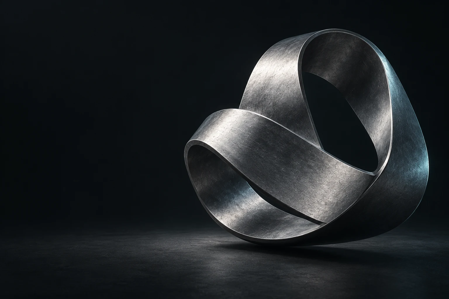 Conceptual silver metal ribbon forming a continuous loop on a dark background